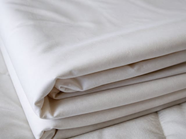 Close-up of folded bed sheets