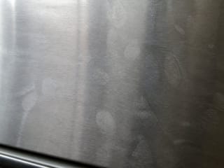 Traces de doigts sur un réfrigérateur en acier inoxydable